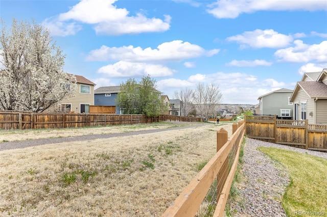 view of yard with a residential view and a fenced backyard