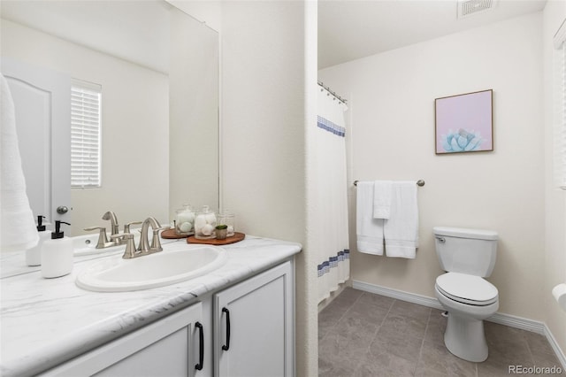 bathroom with tile patterned flooring, vanity, toilet, baseboards, and visible vents