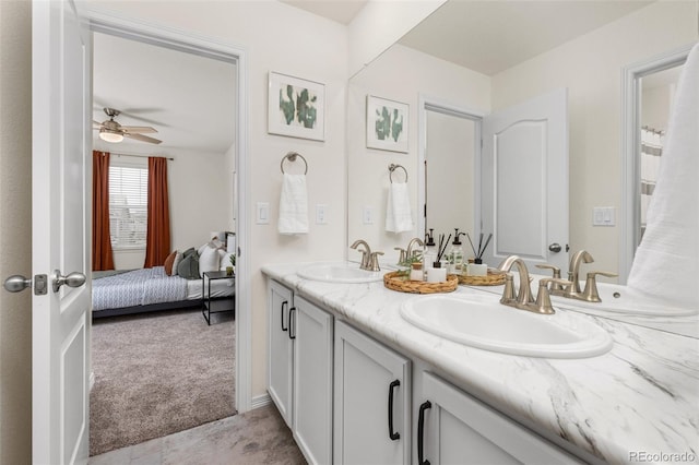 ensuite bathroom featuring double vanity, a sink, connected bathroom, and ceiling fan
