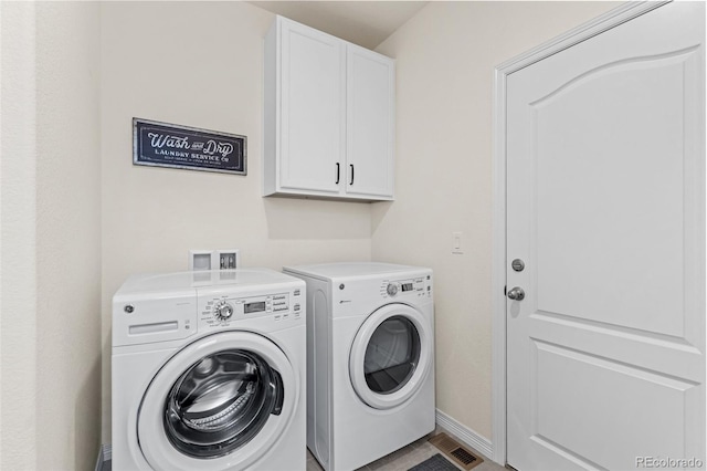 laundry area with independent washer and dryer, baseboards, visible vents, and cabinet space