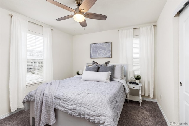 bedroom with baseboards, ceiling fan, and dark colored carpet
