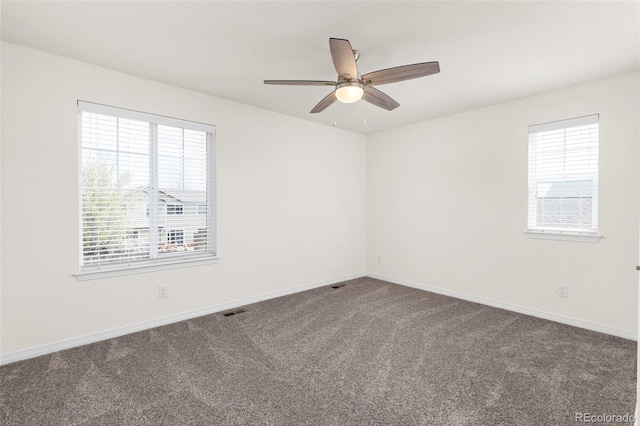empty room with baseboards, carpet flooring, and a healthy amount of sunlight
