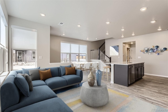 9457 W 58th Ln Unit A, Arvada, CO 80002 - living room featuring light wood finished floors, stairs, and recessed lighting
