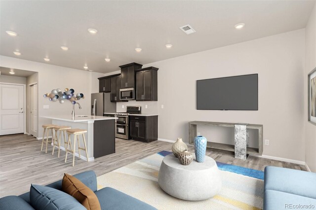 9457 W 58th Ln Unit A, Arvada, CO 80002 - living room featuring light wood-style floors and recessed lighting