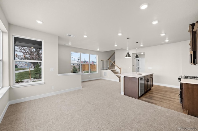 9457 W 58th Ln Unit A, Arvada, CO 80002 - kitchen featuring light countertops, dark brown cabinetry, light carpet, stainless steel dishwasher, and recessed lighting