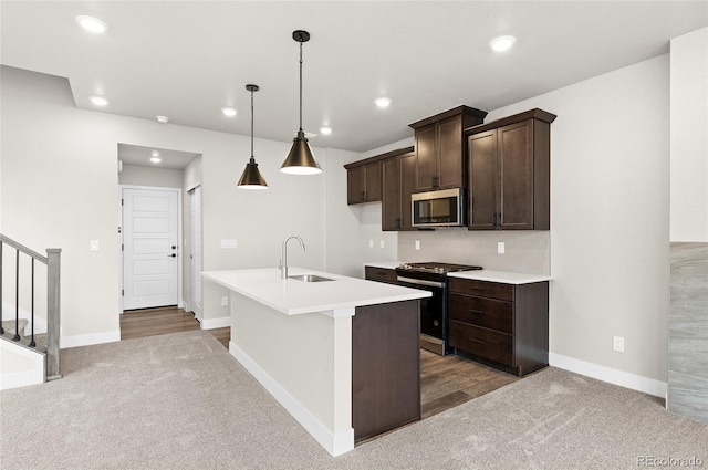 9457 W 58th Ln Unit A, Arvada, CO 80002 - kitchen featuring appliances with stainless steel finishes, carpet flooring, dark brown cabinets, light countertops, and recessed lighting