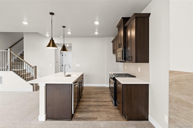 9457 W 58th Ln Unit A, Arvada, CO 80002 - kitchen featuring stainless steel appliances, dark brown cabinets, a center island with sink, light countertops, and recessed lighting