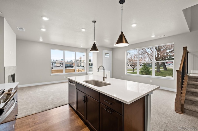9457 W 58th Ln Unit A, Arvada, CO 80002 - kitchen featuring stainless steel dishwasher, light colored carpet, open floor plan, recessed lighting, and light countertops