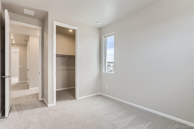 9457 W 58th Ln Unit A, Arvada, CO 80002 - unfurnished bedroom featuring light colored carpet, a spacious closet, and a closet
