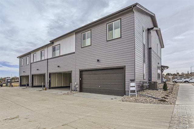 9457 W 58th Ln Unit A, Arvada, CO 80002 - rear view of property with an attached garage and driveway