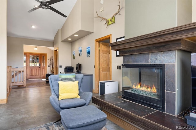 222 Idlewild Dr, Dillon, CO 80435 - living room with concrete flooring, high vaulted ceiling, a tiled fireplace, and a ceiling fan