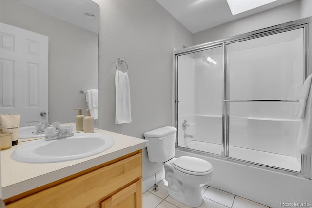 full bathroom with vanity, bath / shower combo with glass door, tile patterned floors, and toilet