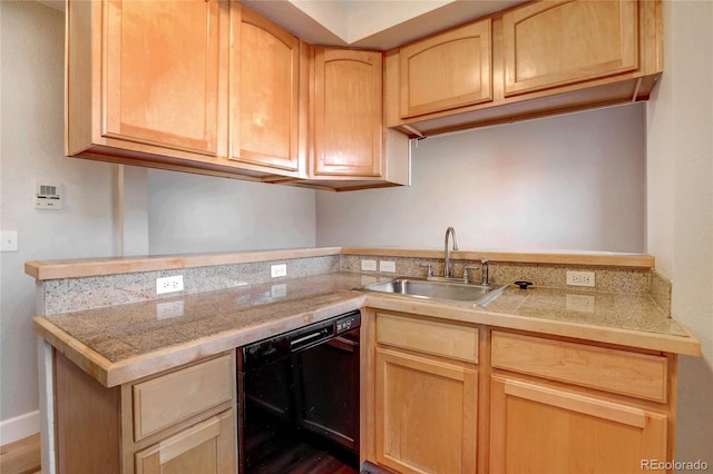 kitchen featuring light brown cabinetry, sink, and dishwasher