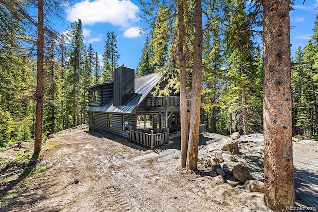 46 Silver Creek Rd, Idaho Springs, CO 80452 - view of front of house featuring a chimney, a metal roof, and log exterior