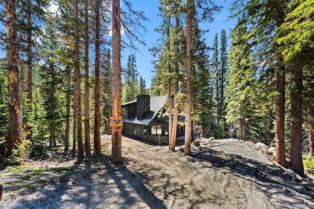 46 Silver Creek Rd, Idaho Springs, CO 80452 - view of front of house featuring a metal roof and a view of trees