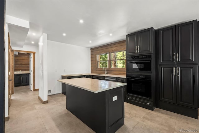 46 Silver Creek Rd, Idaho Springs, CO 80452 - kitchen with dark cabinets, a center island, light stone counters, recessed lighting, and light tile patterned flooring