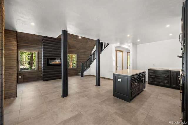 46 Silver Creek Rd, Idaho Springs, CO 80452 - kitchen with dark cabinets, light countertops, recessed lighting, a center island, and a glass covered fireplace