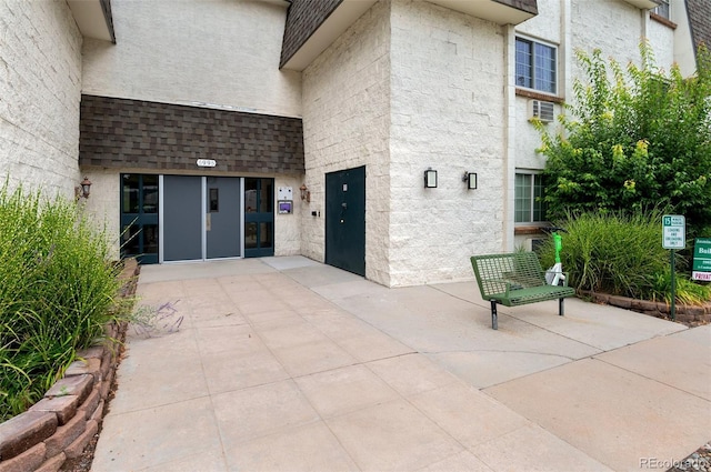 view of exterior entry featuring a patio