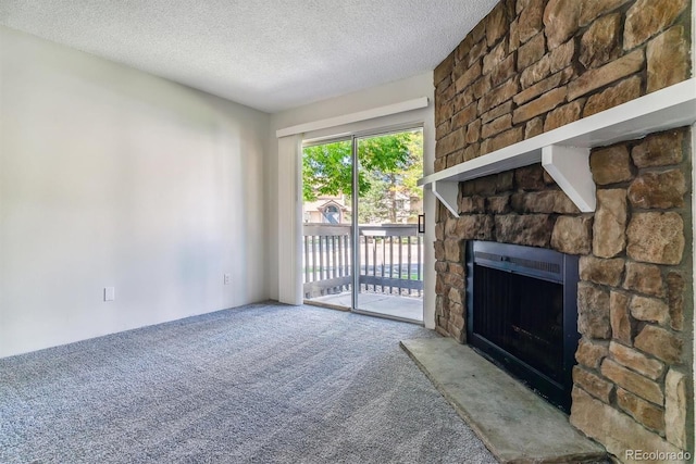 unfurnished living room with carpet flooring, a stone fireplace, and a textured ceiling