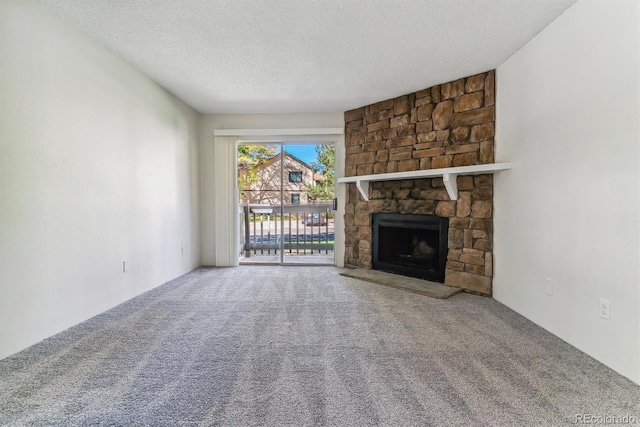 unfurnished living room with a fireplace, carpet floors, and a textured ceiling