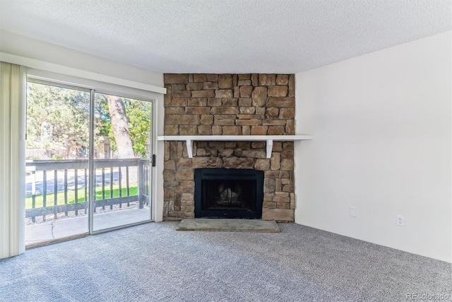 unfurnished living room with a textured ceiling, carpet floors, and a fireplace