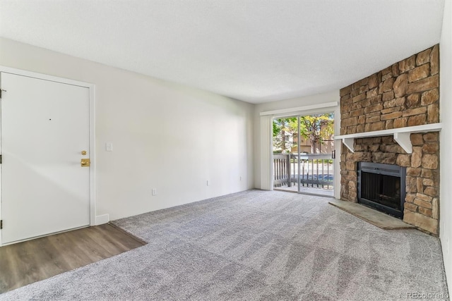 unfurnished living room featuring a fireplace and carpet flooring