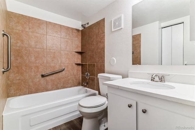 full bathroom featuring toilet, hardwood / wood-style floors, vanity, and tiled shower / bath