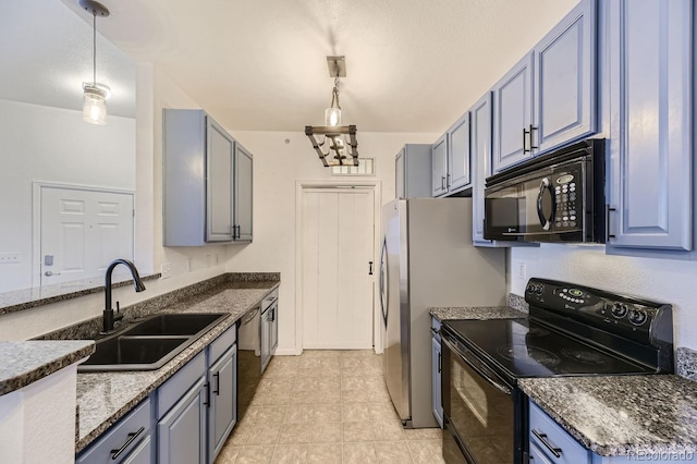 kitchen with black appliances, sink, pendant lighting, and light tile patterned floors