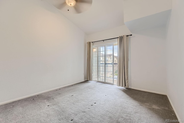 carpeted spare room featuring ceiling fan and vaulted ceiling