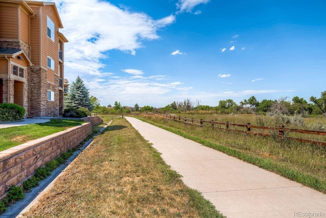 view of home's community featuring a lawn and a rural view