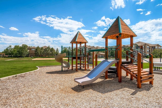 view of jungle gym featuring a lawn