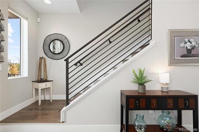 stairs featuring hardwood / wood-style flooring