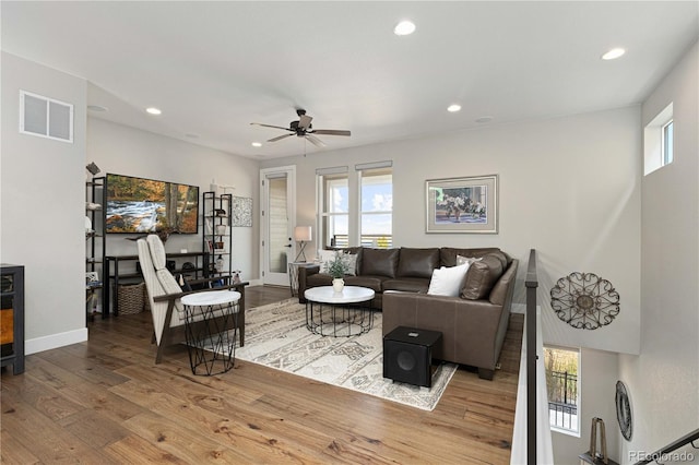 living room featuring light wood-type flooring and ceiling fan