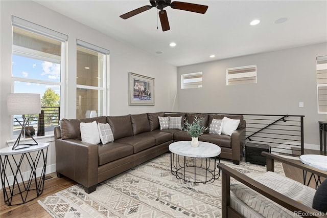 living room featuring ceiling fan and hardwood / wood-style floors