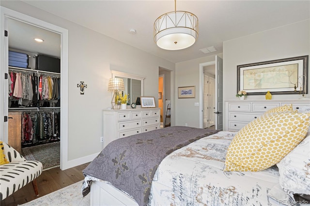 bedroom with a closet and dark hardwood / wood-style floors