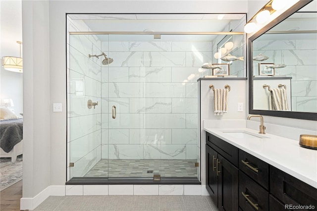 bathroom featuring vanity, a shower with shower door, and tile patterned flooring