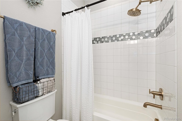 bathroom featuring shower / tub combo and toilet