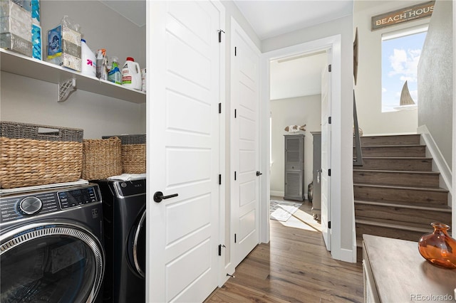 laundry area with hardwood / wood-style floors and washer and dryer