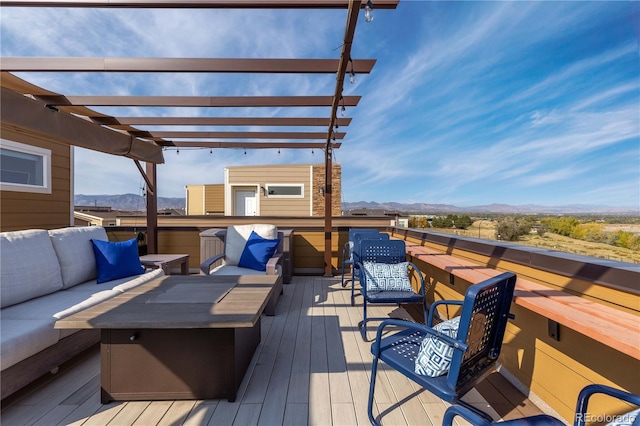 deck featuring an outdoor hangout area, a pergola, a mountain view, and a jacuzzi