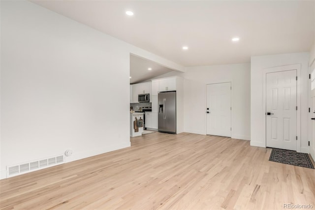 1948 S Zenobia St, Denver, CO 80219 - unfurnished living room with light wood-style flooring and recessed lighting