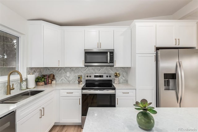 1948 S Zenobia St, Denver, CO 80219 - kitchen featuring stainless steel appliances, backsplash, and white cabinetry