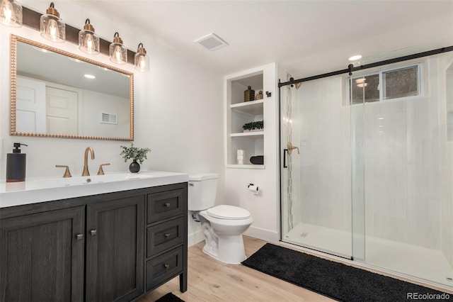 1948 S Zenobia St, Denver, CO 80219 - bathroom featuring vanity, a stall shower, and wood finished floors