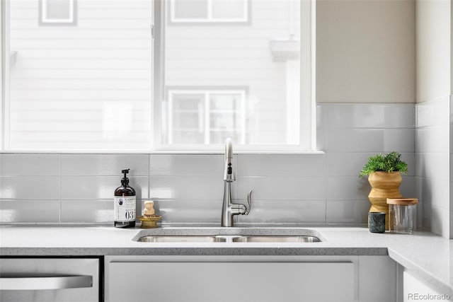 9490 W 14th Ave Unit 3, Lakewood, CO 80215 - kitchen with a sink, dishwasher, white cabinets, backsplash, and light countertops