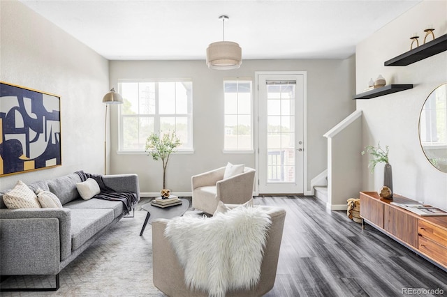 9490 W 14th Ave Unit 3, Lakewood, CO 80215 - living area with healthy amount of natural light, stairway, wood finished floors, and baseboards
