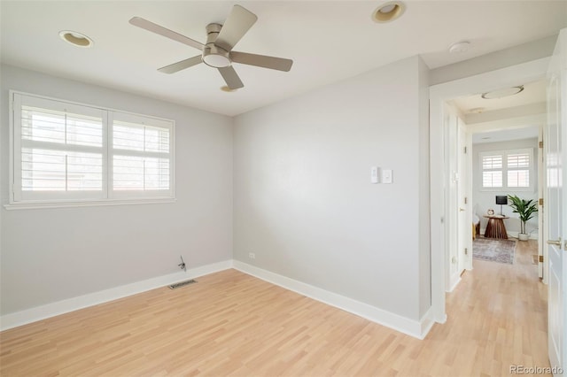 empty room with visible vents, recessed lighting, light wood finished floors, ceiling fan, and baseboards