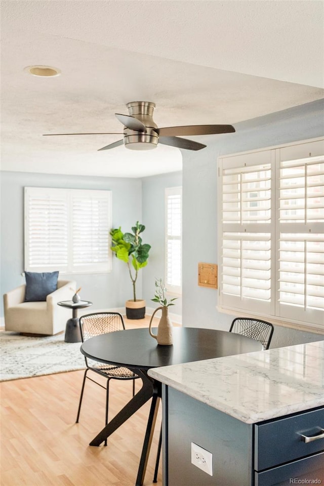 dining space featuring light wood-style flooring and ceiling fan