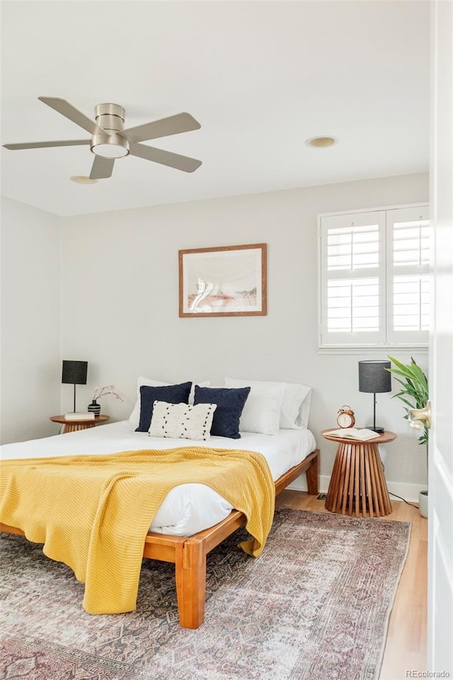 bedroom with a ceiling fan and wood finished floors