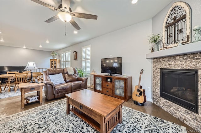 15211 Quince St, Thornton, CO 80602 - living room featuring wood finished floors, a fireplace, a ceiling fan, recessed lighting, and baseboards
