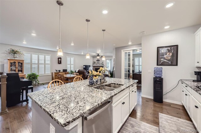 15211 Quince St, Thornton, CO 80602 - kitchen with dishwasher, a sink, open floor plan, wood finished floors, and recessed lighting