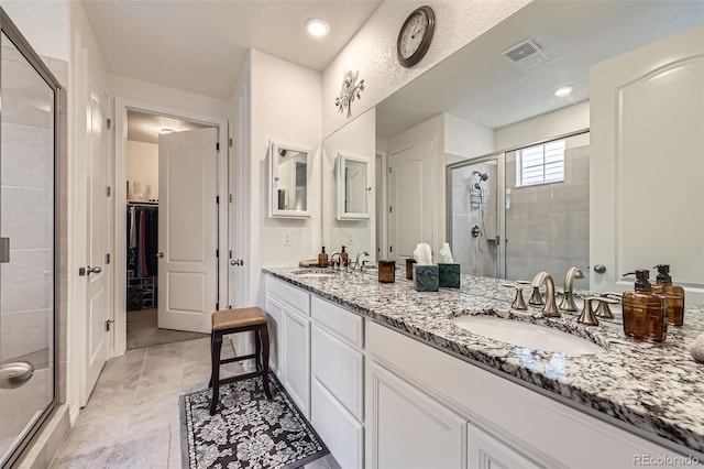 15211 Quince St, Thornton, CO 80602 - full bathroom featuring a shower stall, a walk in closet, and double vanity